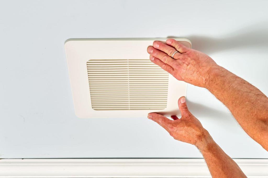 A man installing a ceiling fan in a bathroom in Toronto