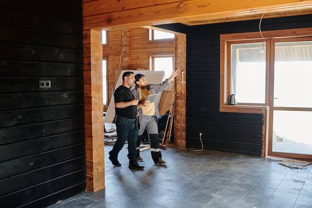 Two people standing in a house undergoing renovations.