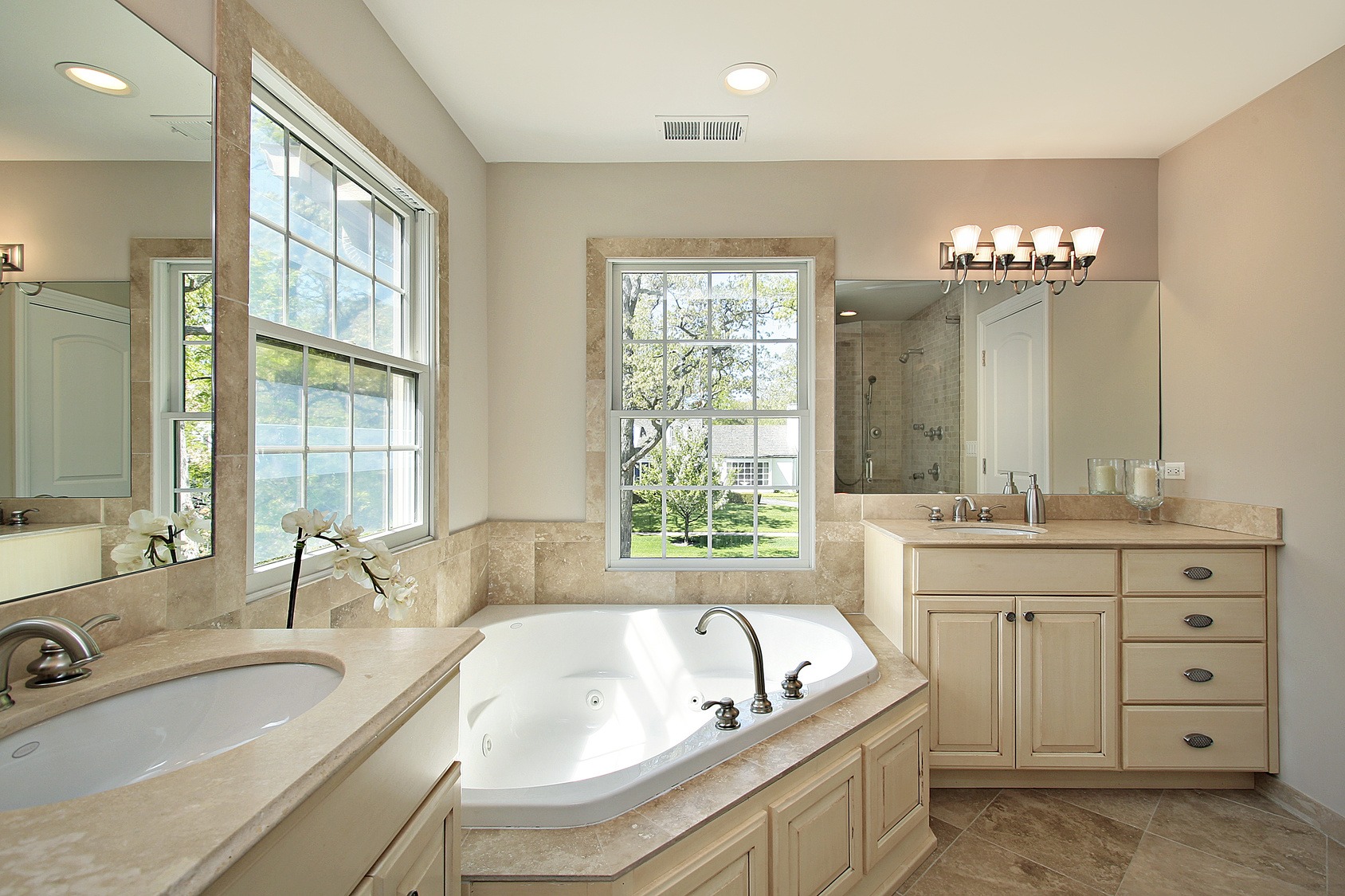 Modern bathroom renovation in Etobicoke, ON, showcasing a large tub alongside a sleek sink.