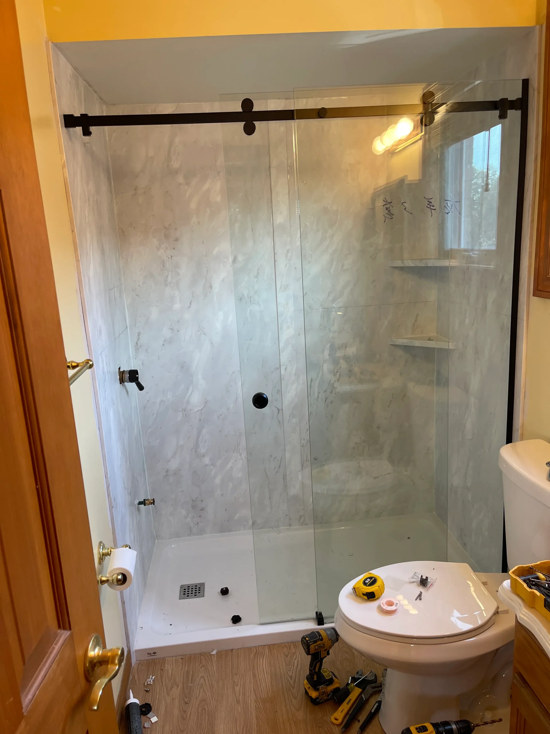 an image about A bathroom with a glass shower door and Acrylic Panels on the walls.