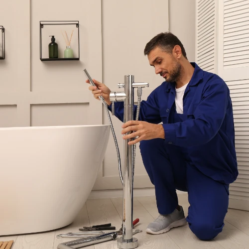 The 2nd process of a plumber working on a bathtub in a bathroom. Bathroom Renovation Cost blog